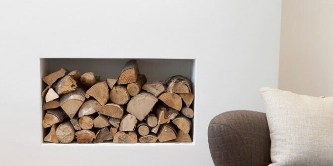 Stack of Firewood in nook in wall indoors